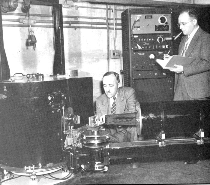 Ernest Wollan (left) and Clifford Shull (standing) working with their neutron diffraction unit at the Oak Ridge Graphite Reactor in 1950.