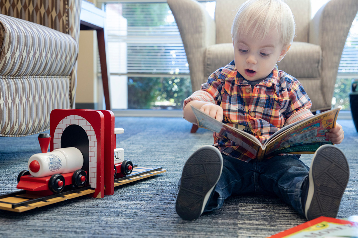 Young boy reading a book