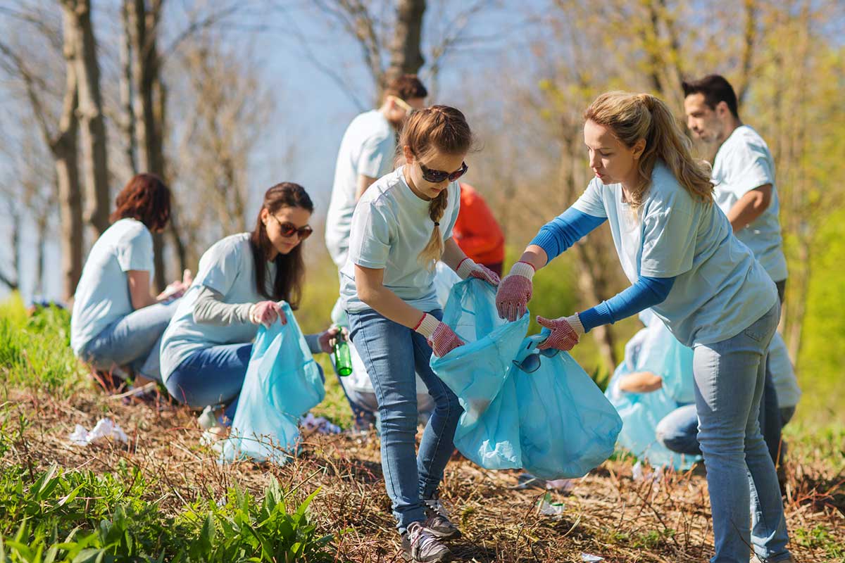 Group of volunteers cleaning roadway