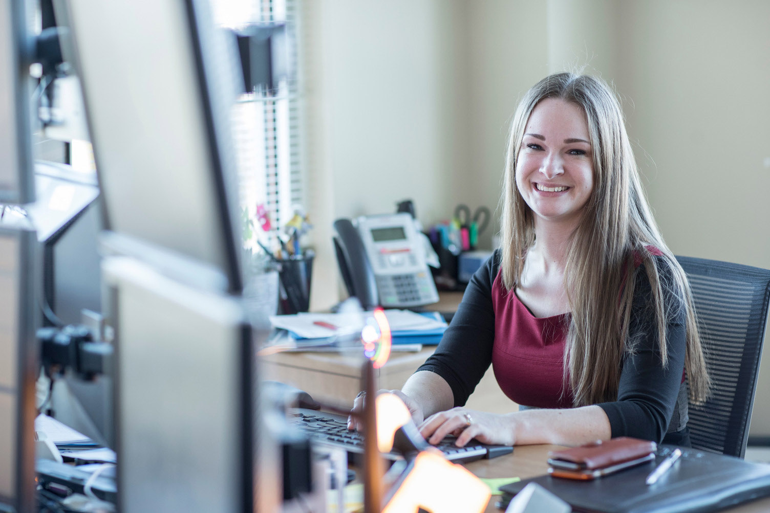 A female employee works at a laptop computer