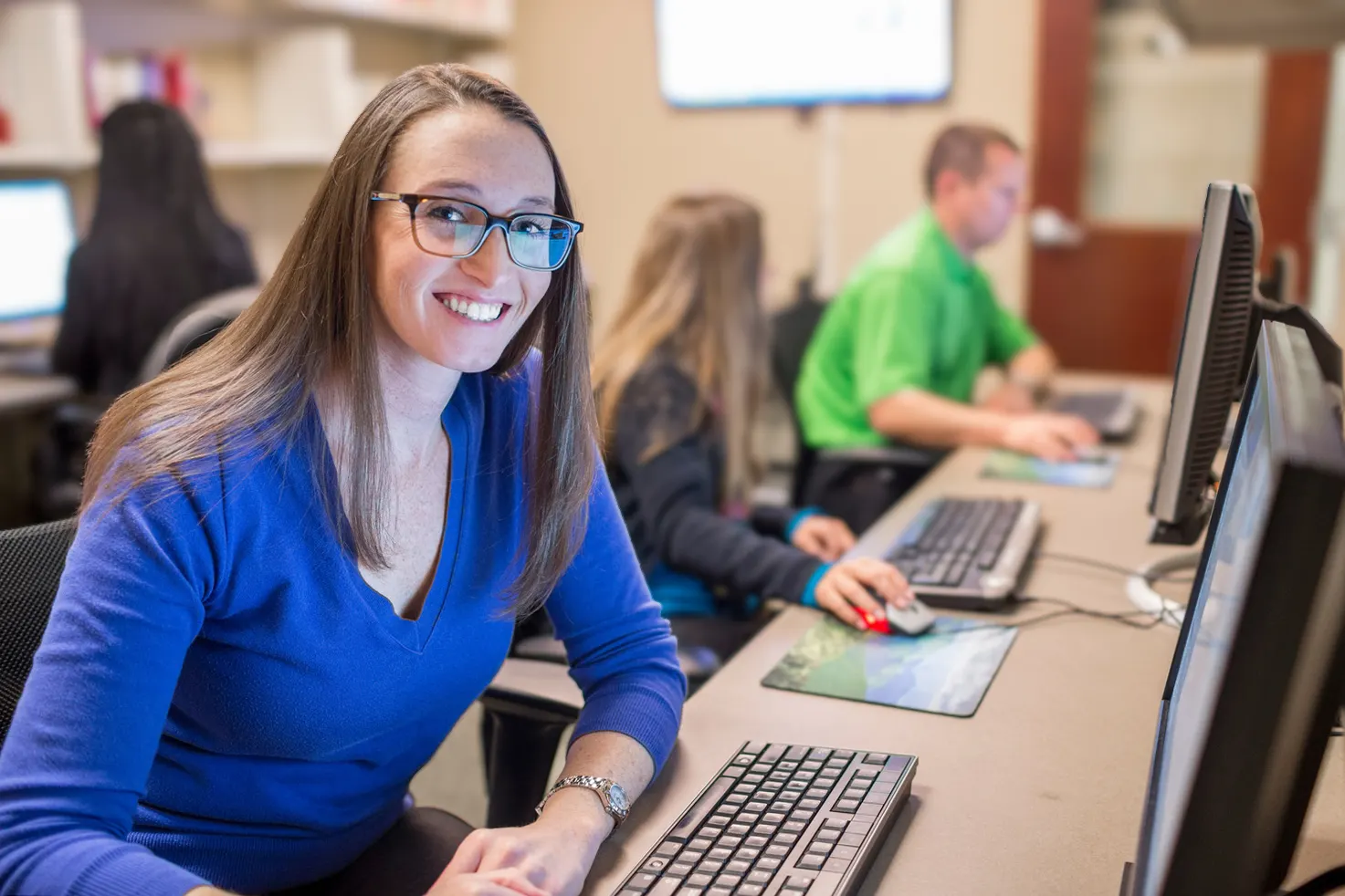 Employees working together in a computer lab
