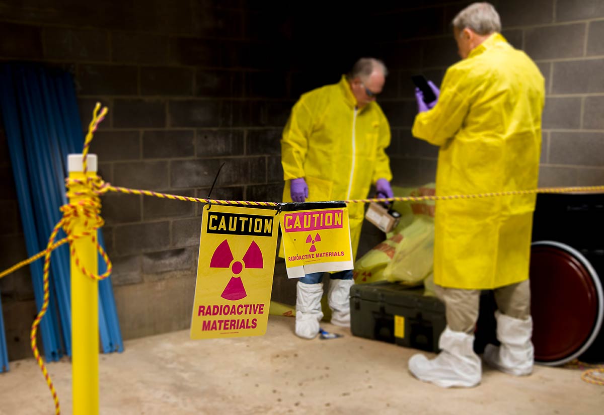 Safety staff testing a work environment for radiation