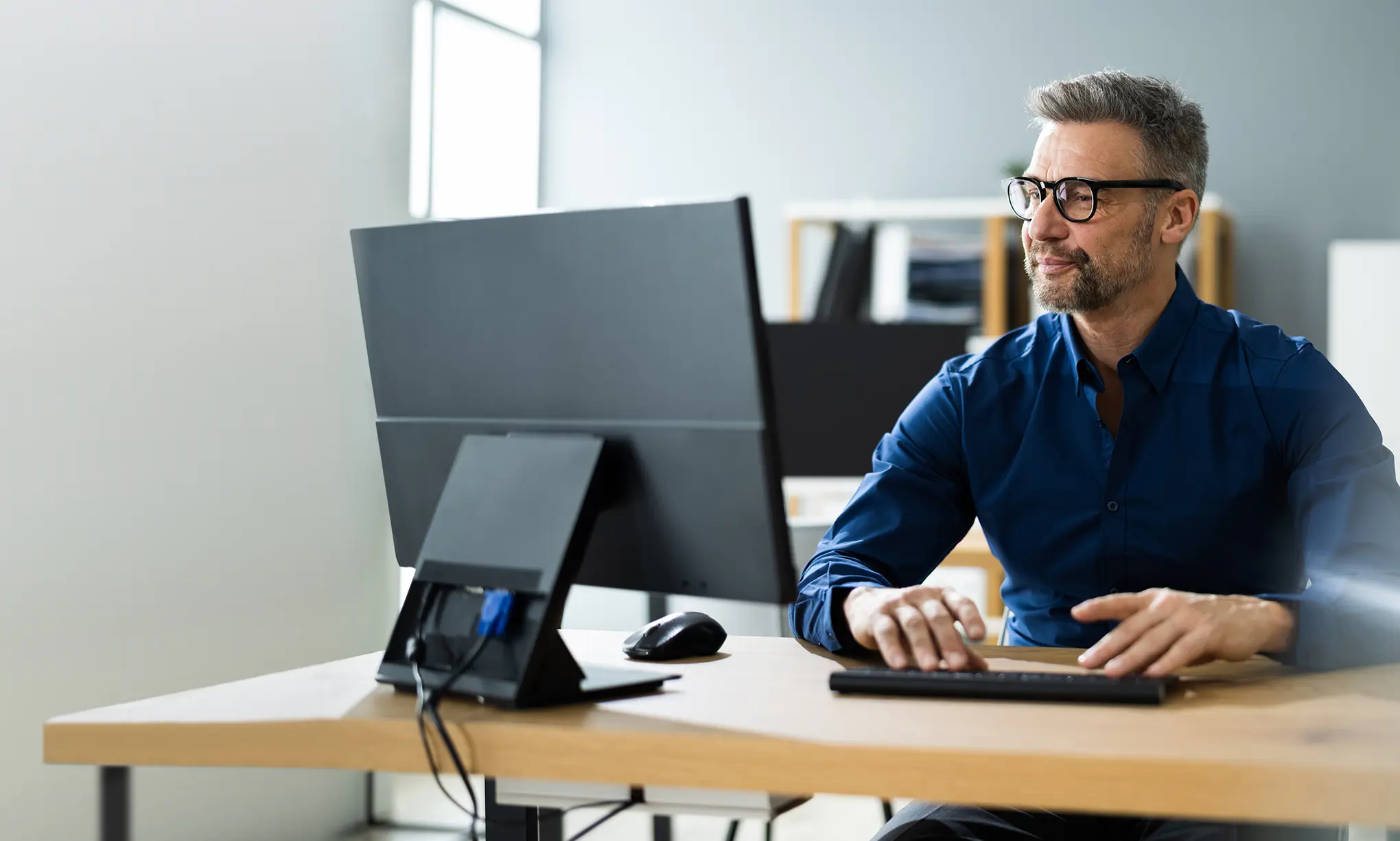 Man works at a laptop in a business setting