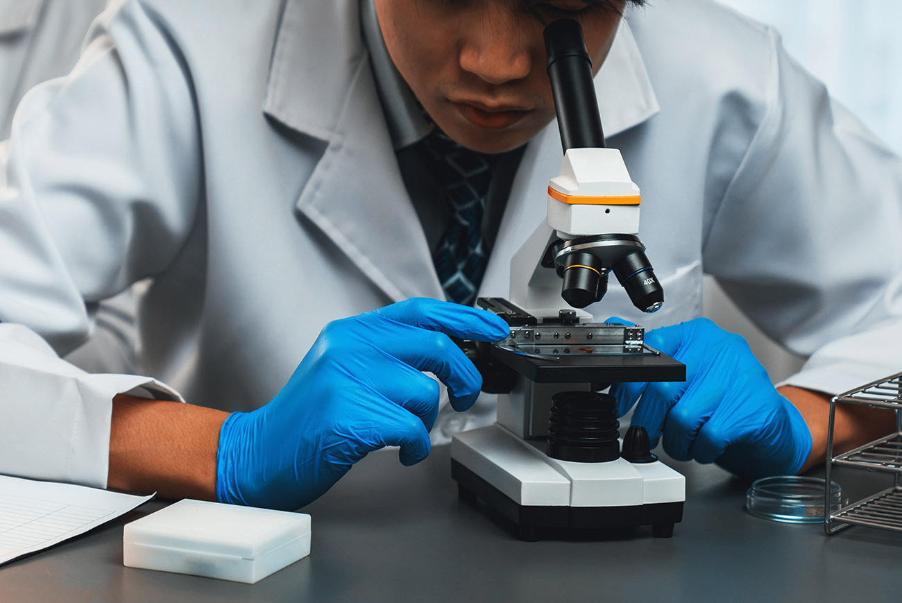 Laboratory scientist looking through microscope