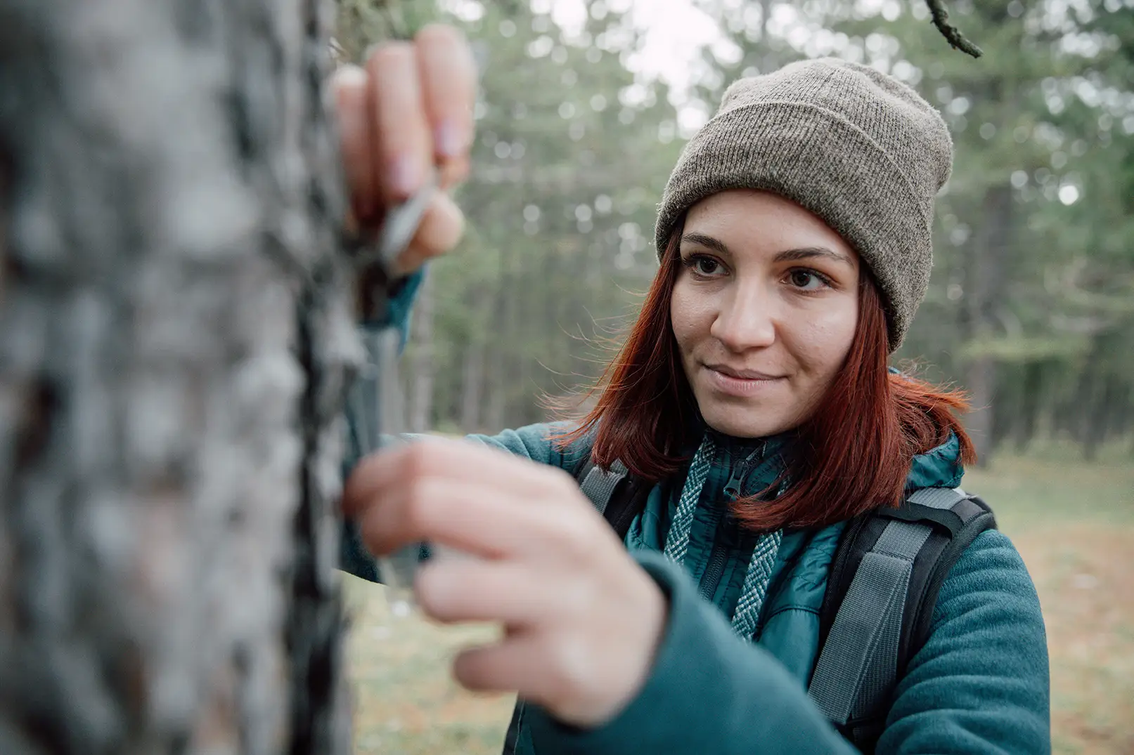 A female intern conducts research in a forest
