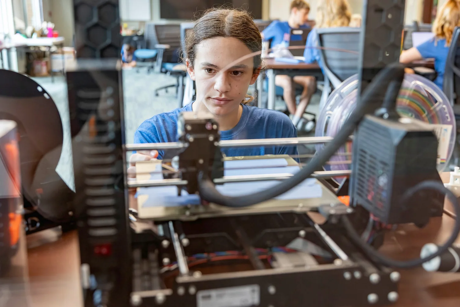 Two female students construct a robot during a STEM workshop 