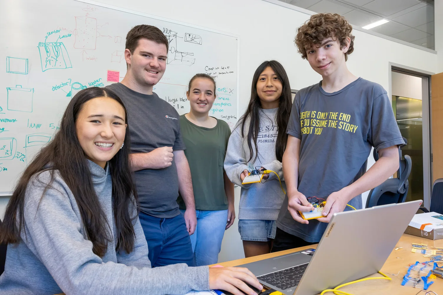 A male high school student participates in a research project during the Appalachian STEM Academy