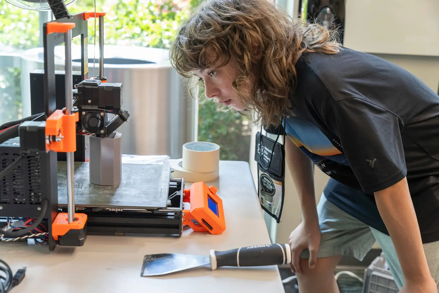 Young students learn about 3D printing from their teacher