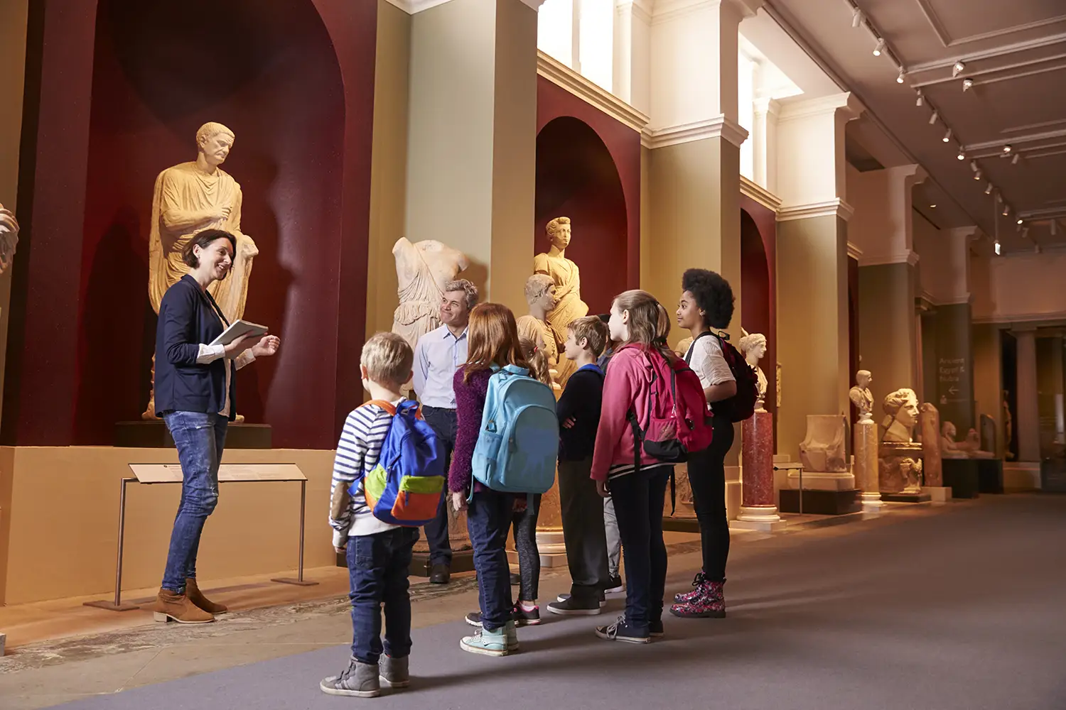 Students and teacher on school field trip to museum