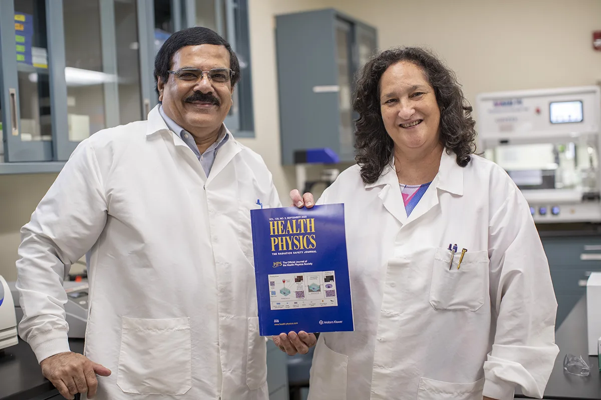 Adayabalam Balajee, Ph.D., and lead biologist Maria B. Escalona hold a copy of the 2023 Health Physics Journal 