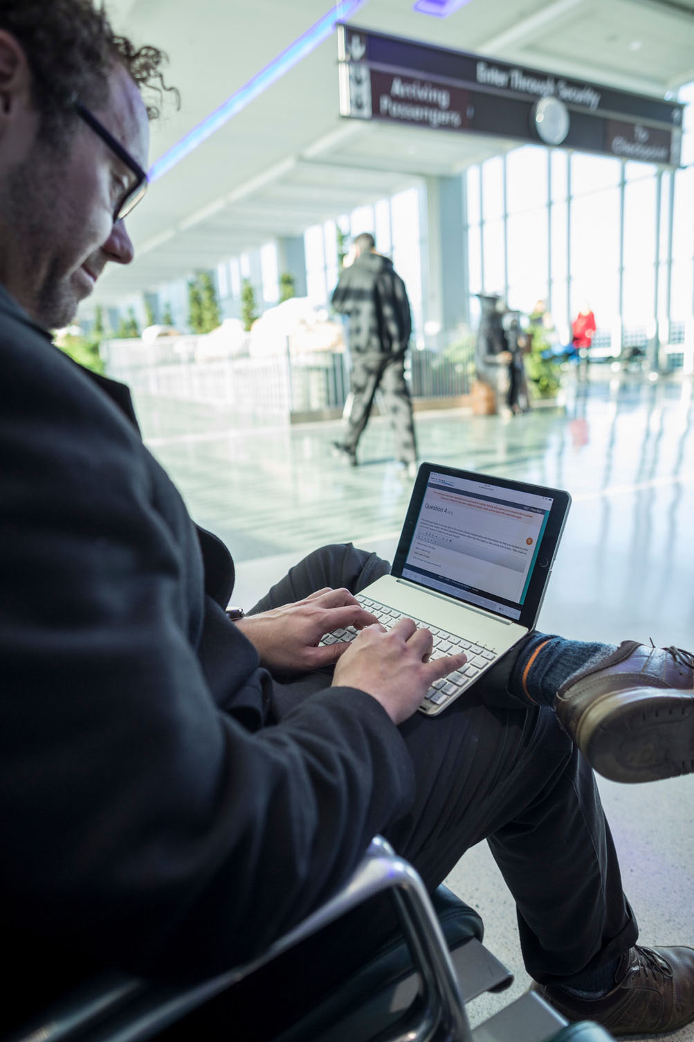 A man uses PeerNet on a tablet at the airport