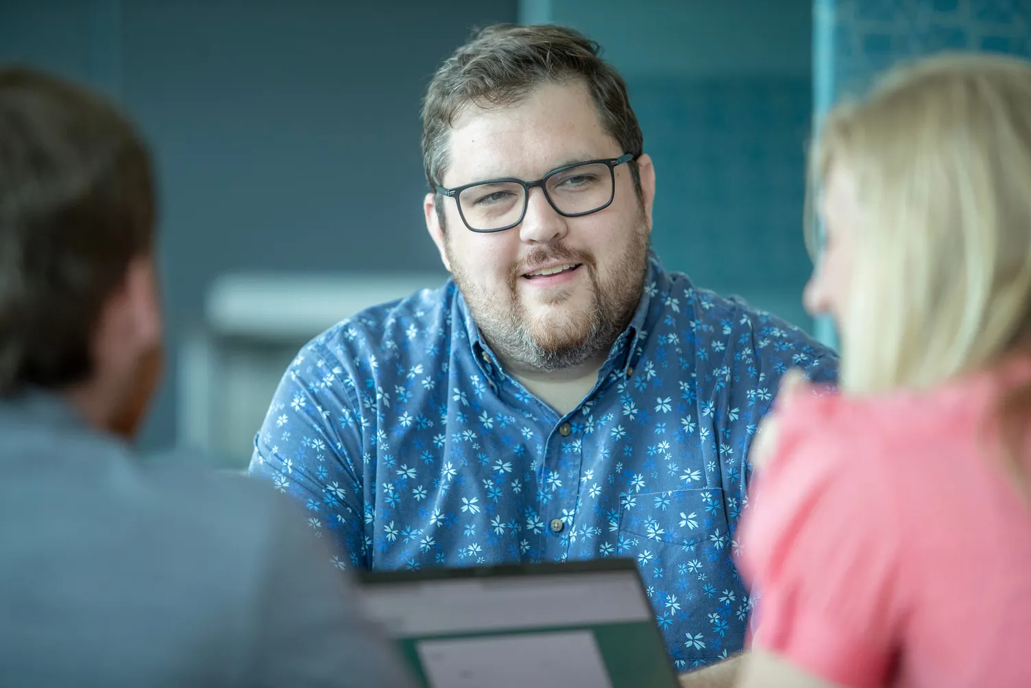 A group of people engage in conversation during a peer review