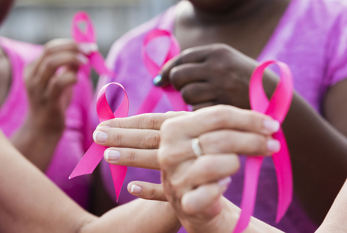 Women holding ribbons for breast cancer awareness