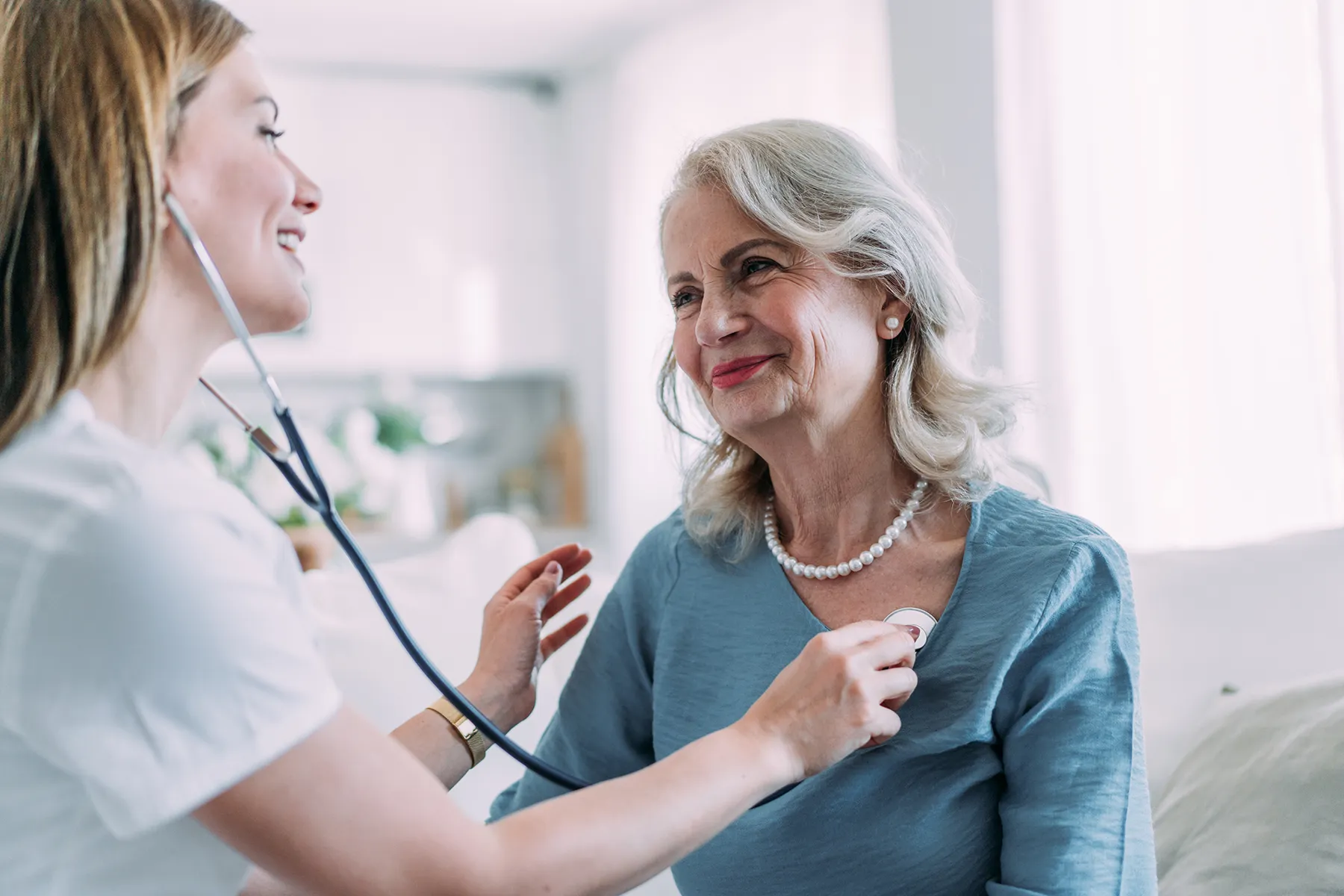 An older woman received care from a female nurse