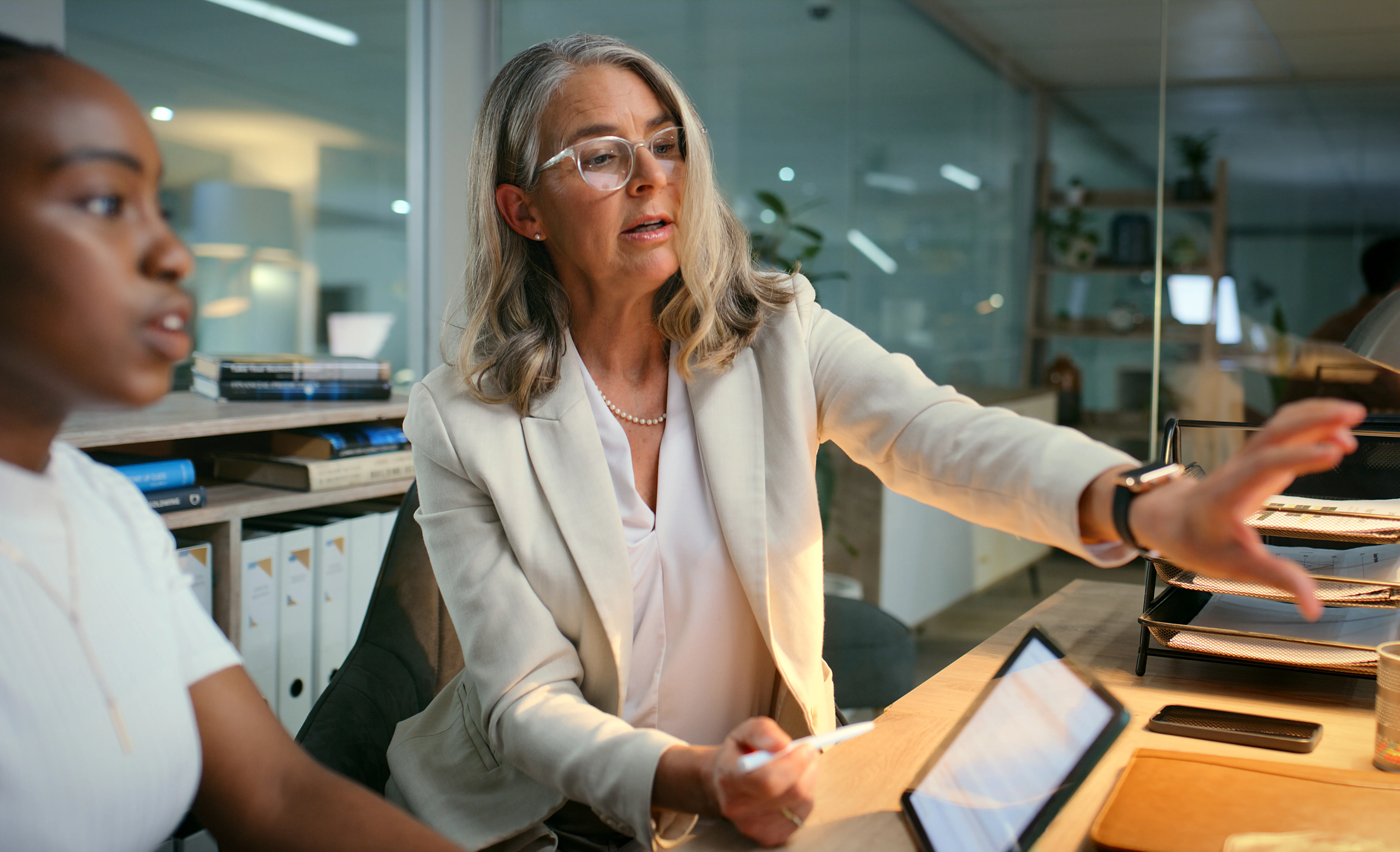 A student and mentor discuss research in an office setting