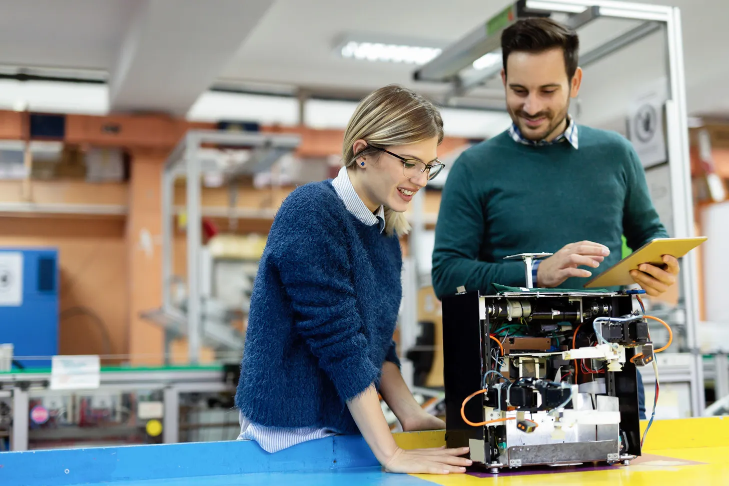 A woman and a man conduct research in a lab setting